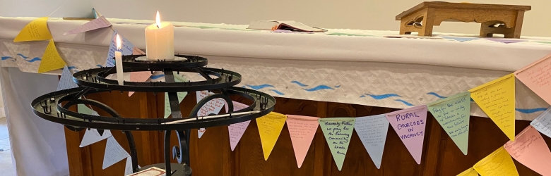 Prayer bunting and candle