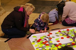 Adult and child creating tree artwork