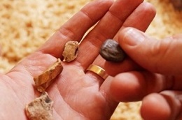 Person counting stones into their hand