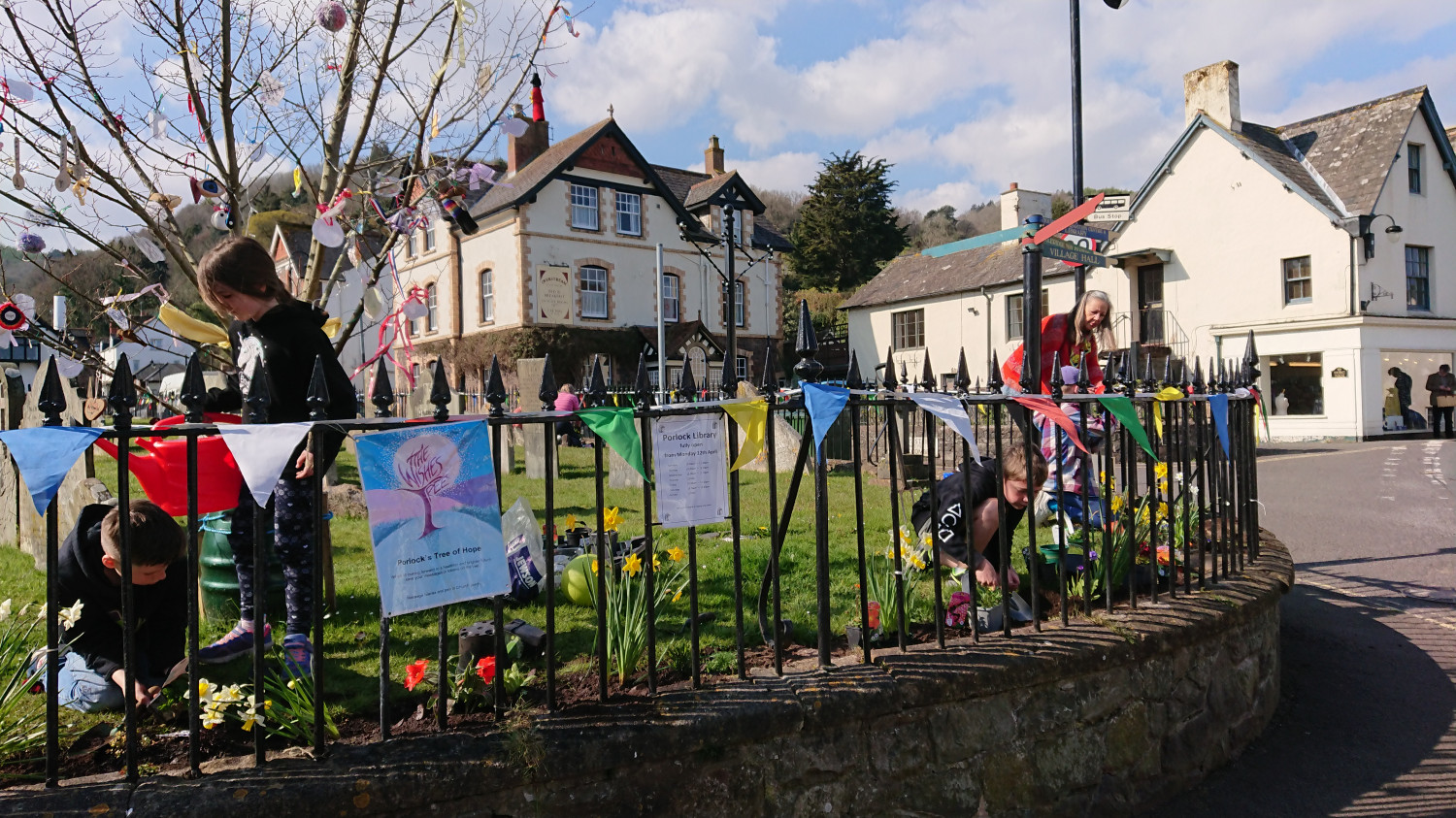 Children decorating railings in porlock