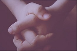 Child's hands clasped in prayer