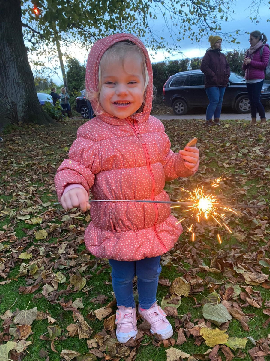 Camp fire church girl with sparkler
