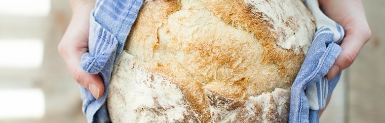 Hands holding a welcoming loaf of bread