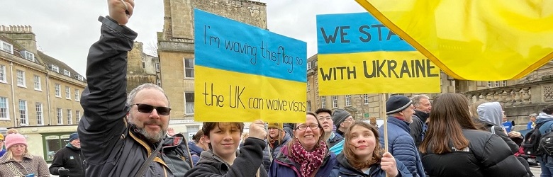 Andrew Avramenko and family with supporting Ukraine banners