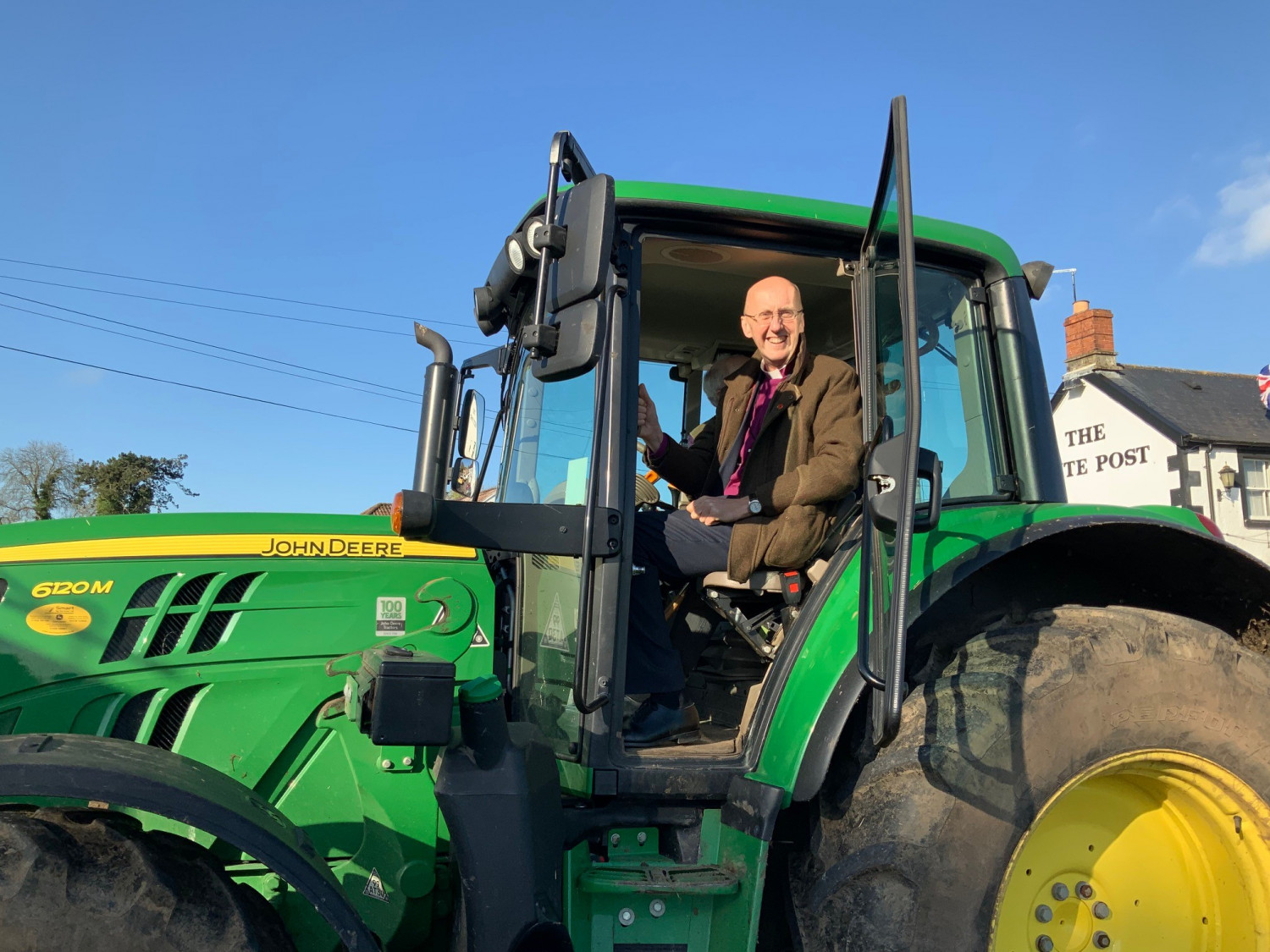Bishop Michael in a tractor
