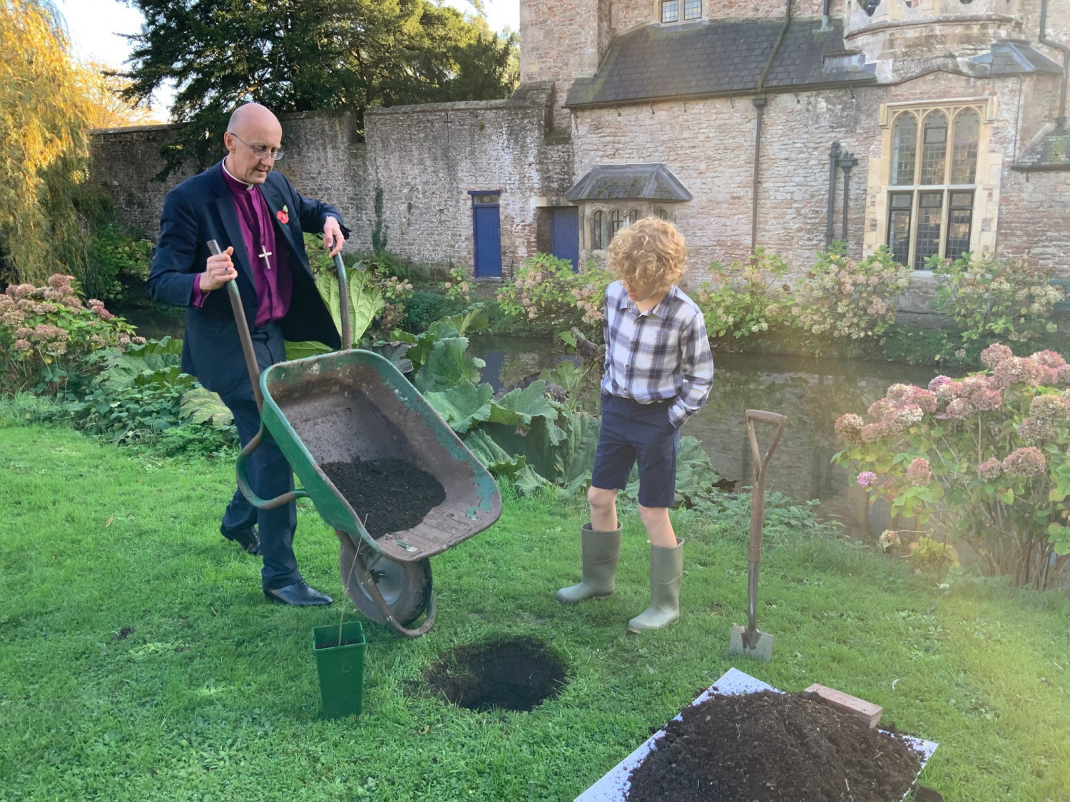 Bishop Michael and Charlie plant a tree at the Bishops Palace